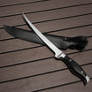  Truscend Forked knife with black sheath on a wooden surface