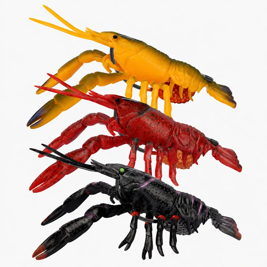 Three toy lobsters in yellow, red, and black on a white background