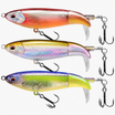 A set of three TRUSCEND topwater fishing lures in minnow design with holographic eyes and realistic fish scales. The lures are in different colors, including silver, gold, and blue.